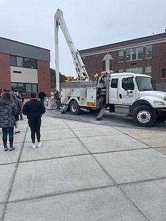 students watch National Grid demo outside their school