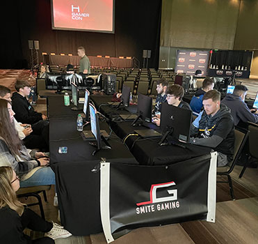 students sitting at computers in convention center