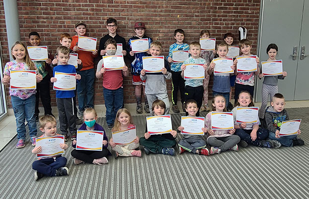 group of students holding certificates