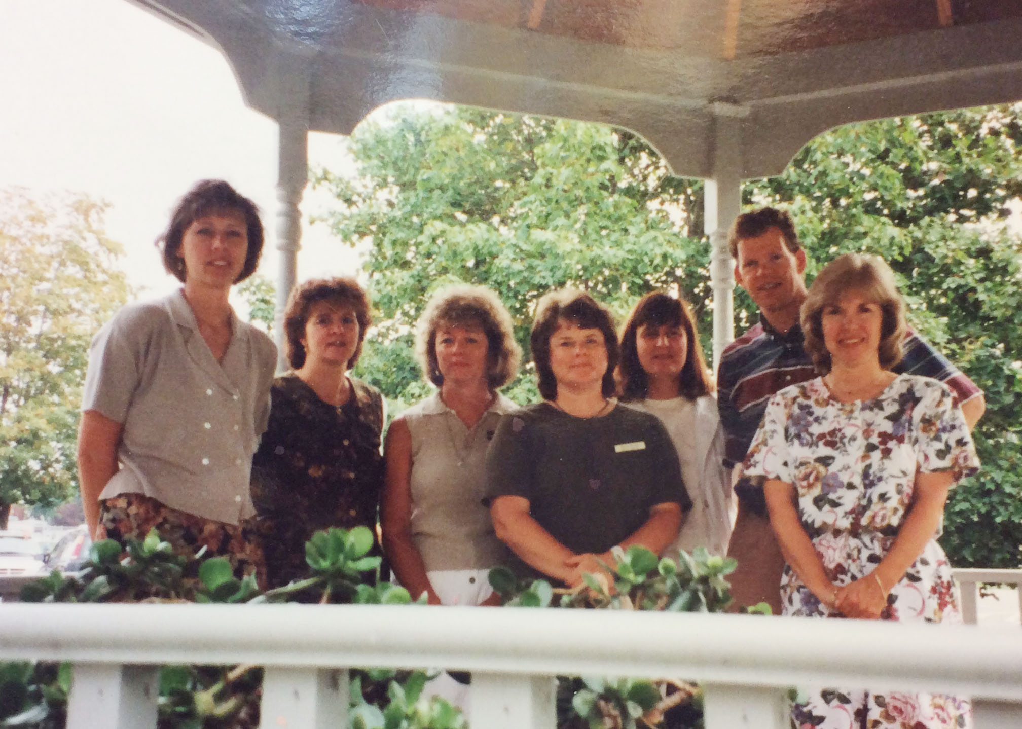 group of people pose from the 1980s