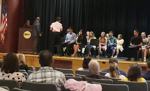 students on stage during induction ceremony