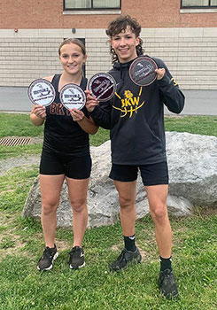 Katie Stevens and Arlan Wright holding medals