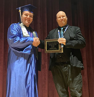 Matthew with Mr. Bevan accepting award at ceremony