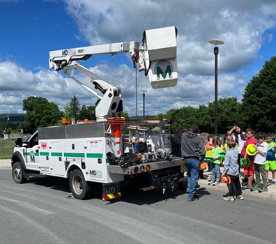 students standing by a bucket truck