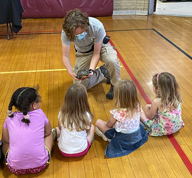 zoo mobile person showing an animal to students