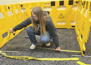 Berne-Knox-Westerlo  High School senior Kaylee Duncan taking measurements of a “crime scene” on the Capital Region BOCES Career & Technical Education enter – Schoharie Campus.