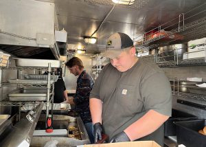 BKW students Tyler Harnett and Nate Lupi joined forces with The Babbling Brook Watering Hole & Eatery owner Brad Stevens to run a food sale to benefit their fellow CTE classmate.