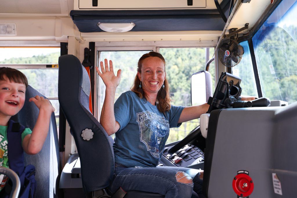 bus driver waving to photographer