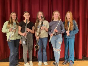 five students standing with wind instruments