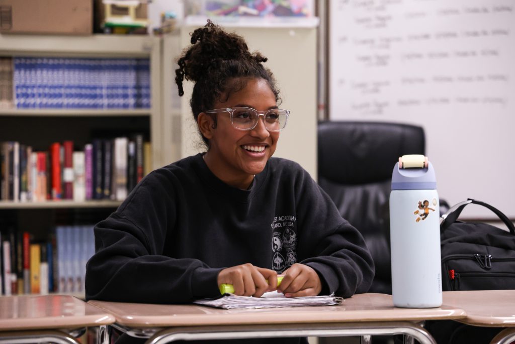 student sitting in class smiling