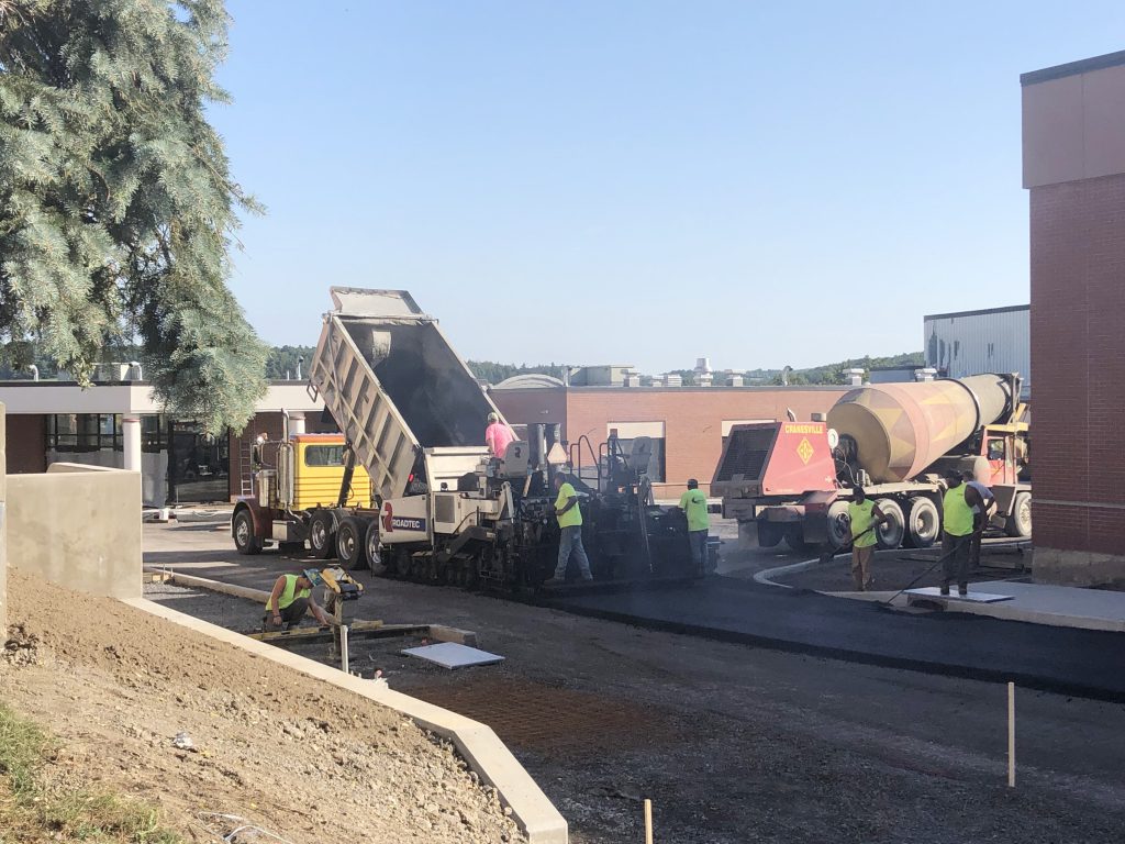 construction crew working on pathway to school building