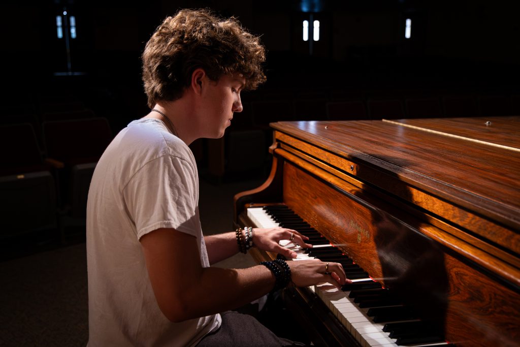 student named philip playing paino