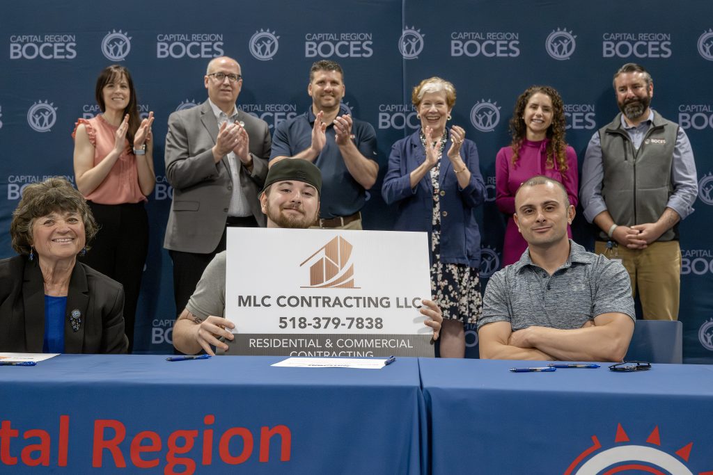 Student holding a CTE signing day certificate at the ceremony